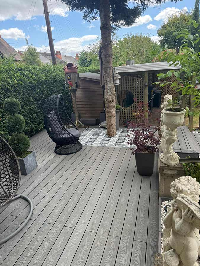 Composite decking including cut out for a tree trunk.